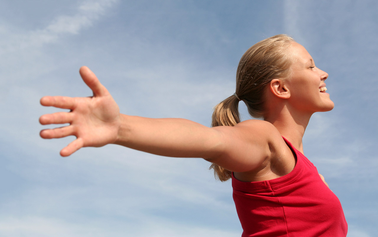 Pain-free, healthy looking woman with outstretched arms